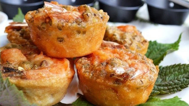 Fried shrimp and vegetable patties served on green leaves with dipping sauces, inspired by the flavors of Vietnam pho.