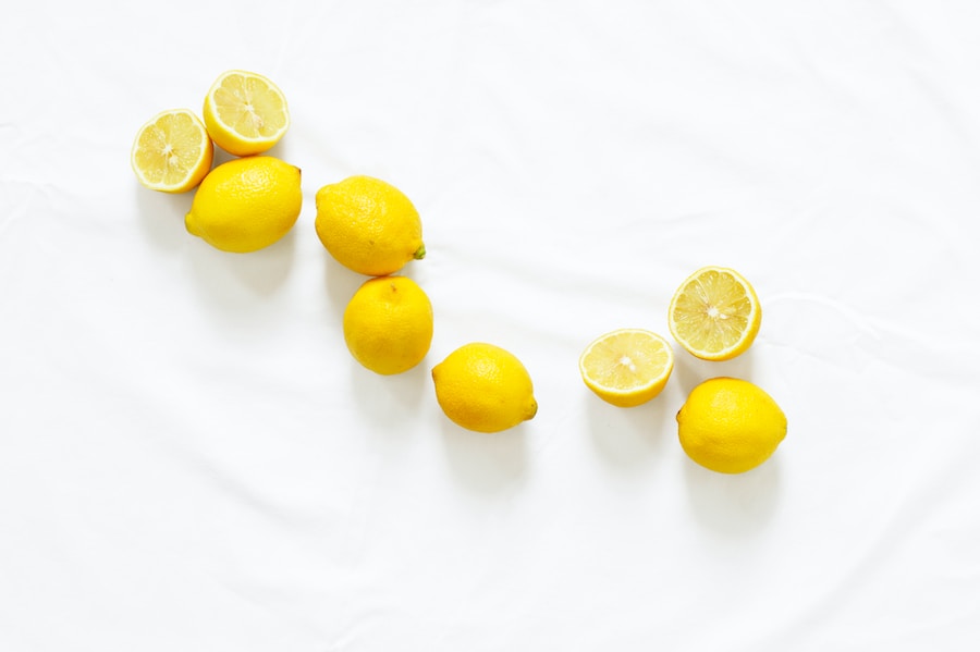 Whole and halved lemons arranged in a curve on a white background, reminiscent of the vibrant flavors found in pho Vietnam.