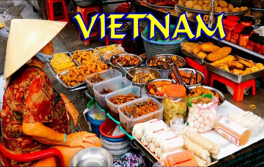 Street food vendor in Vietnam selling a variety of traditional foods including pho.