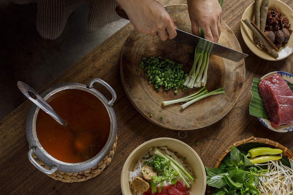 Preparing ingredients for an Asian-style pho meal in Vietnam.