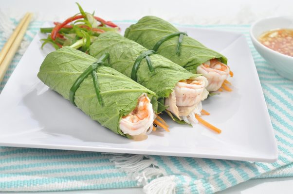 Fresh spring rolls wrapped in lettuce with shrimp and vegetables, served with dipping sauce, a specialty from Vietnam.